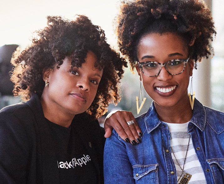 Photo of two women, one confident, one smiling, looking at the reader.