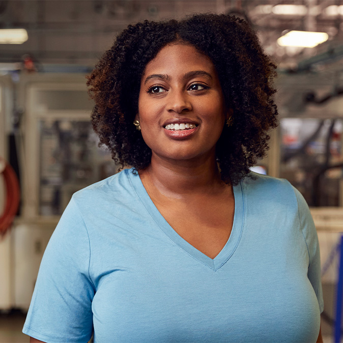 Camara in the Material Recovery Lab, smiling and looking to the side.