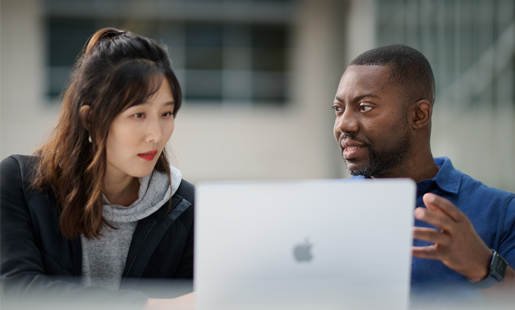 Kofi talking with a colleague.