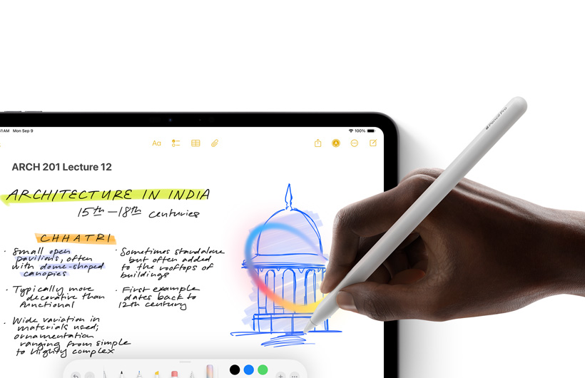 A hand holding Apple Pencil draws a circle around a sketch in the Notes app on iPad.