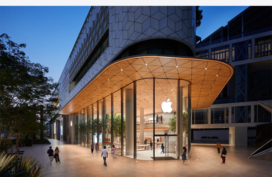 Exterior of a modern Apple store by night.