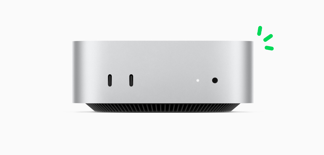 Front view of silver Mac mini showing front ports and indicator light, with carbon neutral story illustrated by small green accents.